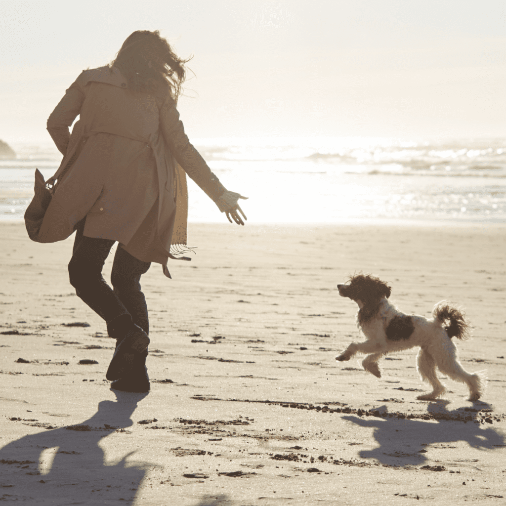 woman and dog at the beach